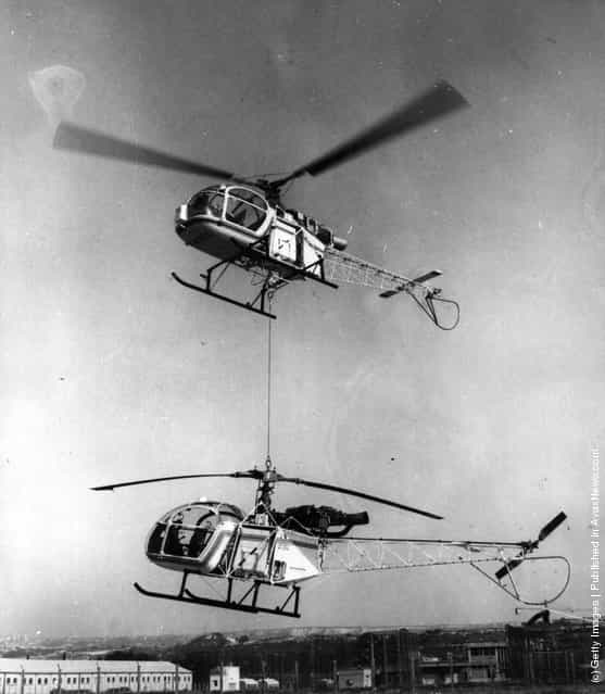 1972: The great lifting power of the French helicopter 'The Lama' currently in production at the Marignana aircraft factory is displayed where it is lifting an Alouette Mark II