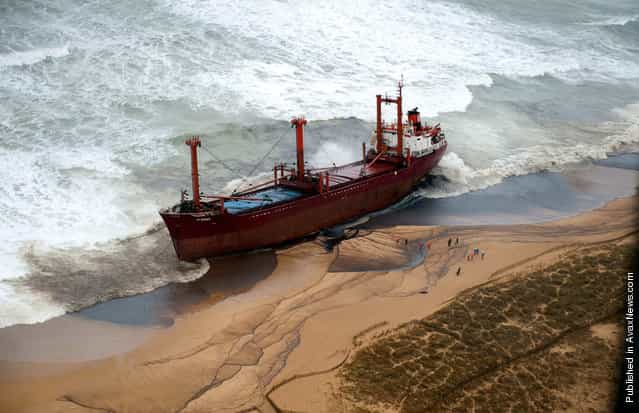 Fuel oil spilled from the stranded TK Bremen covers parts of Kerminihy beach in Erdeven after a storm battered the region on December 16, 2011