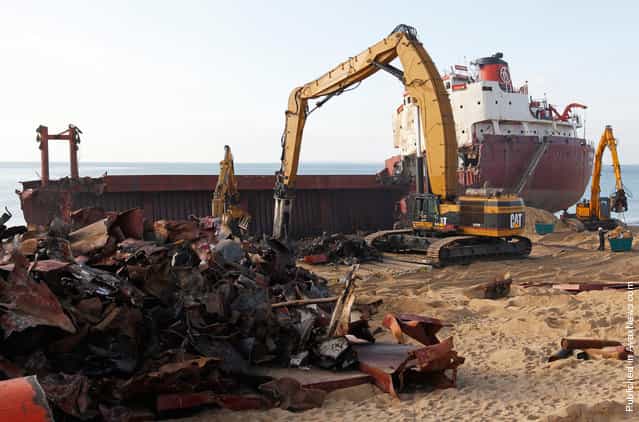 Some of the more than 2,000 tons of scrap lie on Kerminihy beach in front of the carcass of the TK Bremen, on January 13, 2012