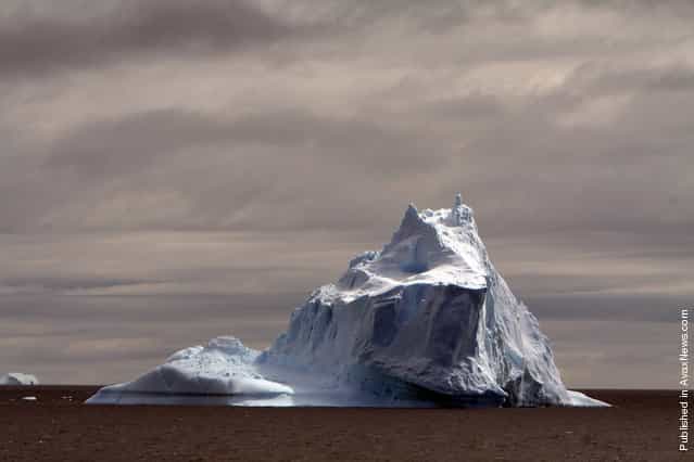 A large iceberg floats off the coast of Antarctica