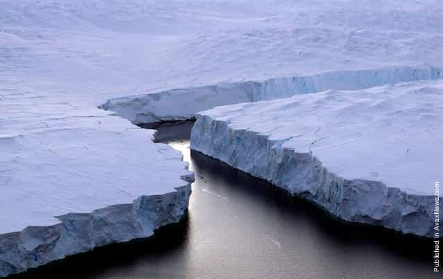 An enormous iceberg, right, breaks off the Knox Coast in the Australian Antarctic Territory