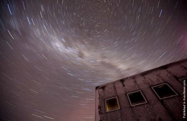 A 20-minute exposure reveals the southern celestial axis above the new elevated station at Amundsen-Scott South Pole Station on July 21, 2009. At the poles, scientists can study a fixed point in the sky for months and years, whereas in the middle latitutes the stars 'move' across the night sky. The white cloudy streak is the Milky Way