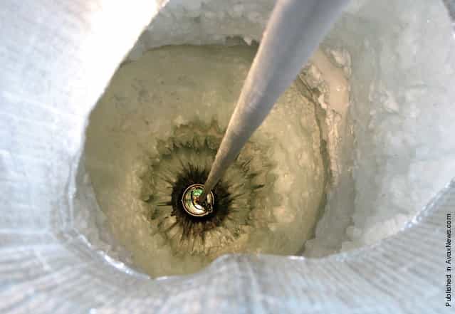 A Digital Optical Module (DOM) is lowered into a 2,500 meter-deep hole in the ice on January 4th, 2006, part of the IceCube Neutrino Observatory