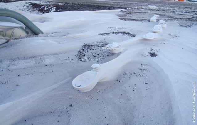 Raised footprints in the Antarctic snow. After a storm, the loose snow surrounding the compacted snow under a footprint is scoured away by the wind, leaving an elevated strange-looking footprints