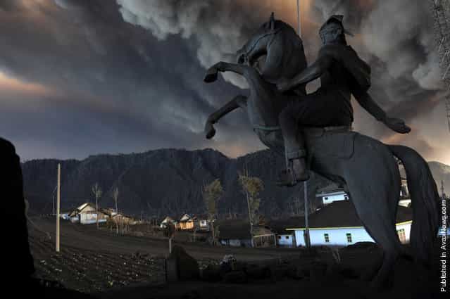 An ash-covered statue stands at the entrance to the village of Cemoro Lawang near the active Mount Bromo volcano in the east of Indonesias central Java island early on December 24, 2010. Photo part of a series winning the 3rd prize for Nature Stories in the World Press Photo Contest