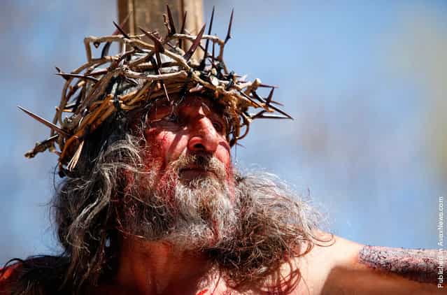 Joe Sanchez hangs on the cross during a re-enactment of the crucifixion of Jesus at Our Lady of Sorrows Church outside El Santuario de Chimayo in Chimayo, New Mexico, on April 22, 2011