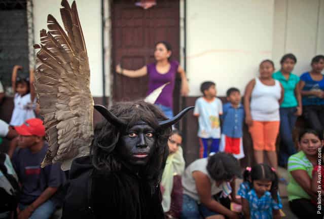 A man performs as a devil during a Holy Week Via Crucis in Masaya, Nicaragua on Thursday