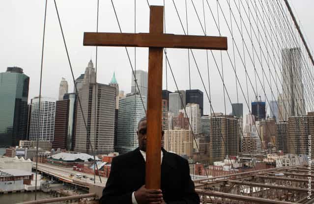 Frank Simmonds carries the cross in the Way of the Cross procession over the Brooklyn Bridge on April 22, 2011 in New York City. The traditional Catholic procession on Good Friday recalls the crucifixion of Jesus Christ ahead of Sunday's Easter holiday