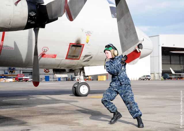 Aviation Machinist's Mate Airman Sarah Rutledge, assigned to the Golden Swordsmen of Patrol Squadron (VP) 47, inspects propeller number four for damage as part of a daily inspection
