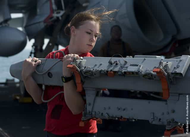 Aviation Ordnanceman 3rd Class Alecia Crockett, assigned to the Kestrels of Strike Fighter Squadron (VFA) 137, moves a BRU-41 multiple ejector rack on the flight deck of the Nimitz-class aircraft carrier USS Abraham Lincoln (CVN 72)
