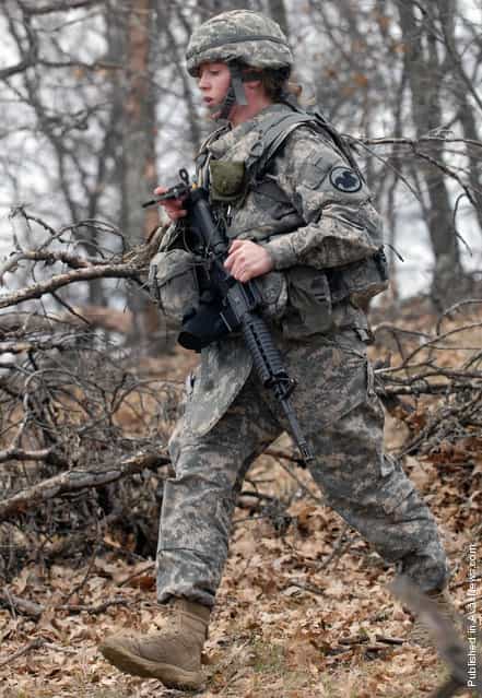 Staff Sgt. Stephanie M. Piekarczyk with the Non- Commissioned Officer Academy at Fort Dix, N.J., follows her compass to her next point for the daytime land navigation event of the 2011 Regional Army Reserve Best Warrior Competition here May 3