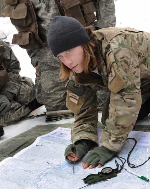 Senior Airman Charlene Plante, 22nd Training Squadron, Survival Evasion Resistance Escape specialist, teaches her students triangulation March 13, 2011 in Colville National Forest, Wash., The purpose of this block of training is to teach students how to pinpoint their location using a map, compass and sticks