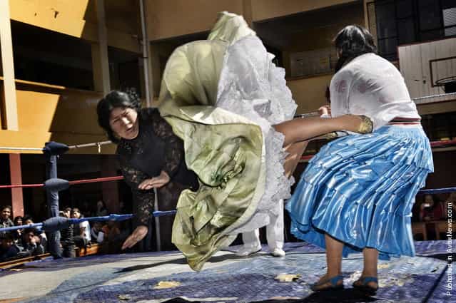 Women Wrestlers, Bolivia. Lucha libre (Bolivian wrestling) is one of the most popular sports in the country. Women wrestlers are known as cholitas and have in the last ten years become popular in the sport. Here, Carmen Rosa and Yulia la Pacena perform in a benefit show to raise money for the bathrooms of a school in La Paz, Bolivia, 26 June 2011