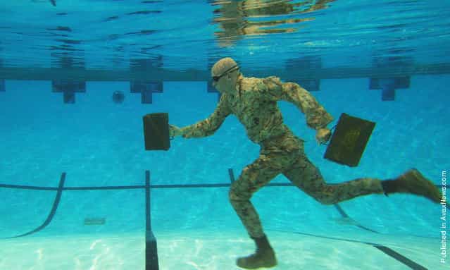 U.S. Marine Corps Lance Cpl. Reagan Lodge, Headquarters and Service Battalion, Marine Corps Base Quantico, conducts water running exercises during a phyiscal training session in Ramer Hall, The Basic School, on Marine Corps Base Quantico