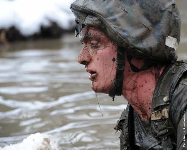 A candidate from Officer Candidate School swims through icy waters during the Quigley in order to complete a combat course at Marine Corps Base Quantico, Va., Jan., 29, 2011. The Quigley involves going through obstacles in water which includes a full immersion underwater