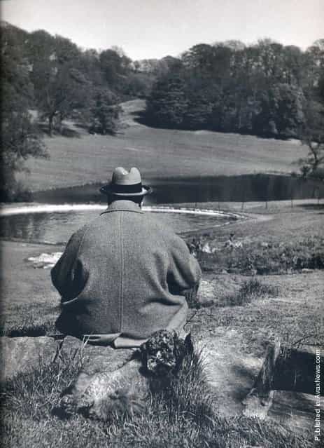 British Prime Minister Winston Churchill with his poodle, Rufus, in the gardens of his Chartwell estate, 1951. Photo by Philippe Halsman