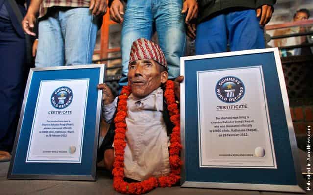 Nepals Chandra Bahadur Dangi poses with his certificates after being declared the worlds shortest living man and shortest man ever by the Guinness Book of Records at a ceremony in Katmandu, Nepal, on Feb. 26, 2012. The 72-year-old man was measured at just 21.5 (54,61 cm) tall, snatching the title from Junrey Balawing of the Philippines, who is 23.5 inches (59,69 cm)