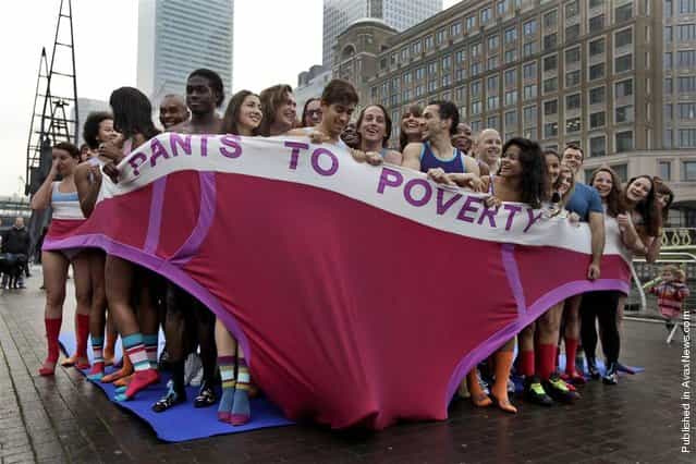 Participants in their underwear break a world record for the most number of people, 57, to fit into an oversized pair of underpants. They look like theyre freezing standing in the Canary Wharf district of London, on Nov. 17, 2011