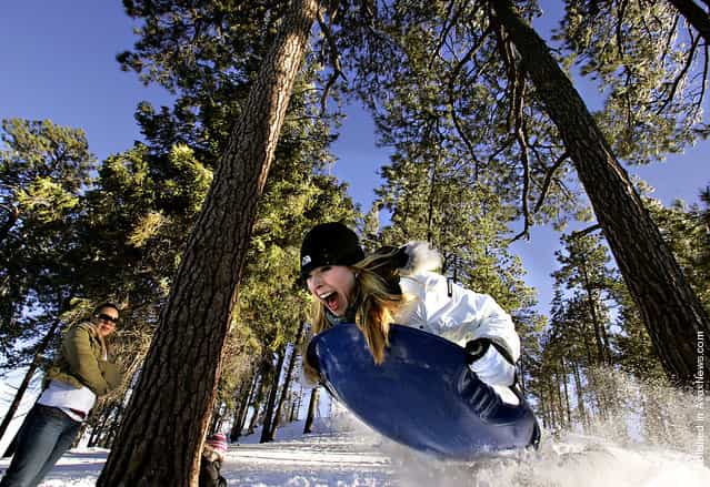 Lindsay Heimbach goes airborne while sledding down a hill on Mt. Lemmon Dec. 27, 2008. Scores of others had the same idea as traffic lined up to take advantage of the snow which was estimated to be between 27-36 inches deep at Ski Valley, which opened for the first day
