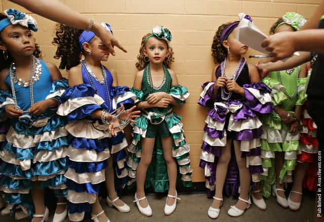 Anissa Delsi, 7, center, receives directions backstage along with fellow dancers prior to taking the stage at the Tucson Music Hall for a performance by the Viva Performance Art Center