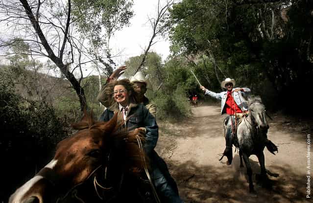 Arided Martinez, 16, lets go of a nervous smile as Jesus Icedo, 16, directs the horse they are riding into a full gallop. The pair were riding in a 32 kilometer [cabalgata] or horseback ride that was organized by the state of Sonora to celebrate the agrarian roots off the state