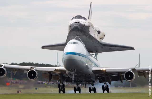 Discovery and the shuttle carrier aircraft land at Dulles International Airport in Chantilly, Virginia, on Tuesday, April 17, 2012