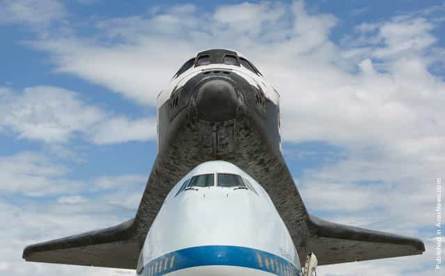 Its final flight complete, the space shuttle Discovery, sits on the Dulles International Airport tarmac under blue skies, on April 17, 2012. Discovery will be lifted from the carrier aircraft shortly, and will towed to the National Air and Space Museum's Udvar-Hazy Center for display