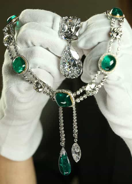 Caroline de Guitaut, Curator of Royal Collections, holds the Cullinan III and IV Broach and the Cullinan VII Delhi Durbar Necklace and Cullinan Pendant at The Queens Gallery, Buckingham Palace