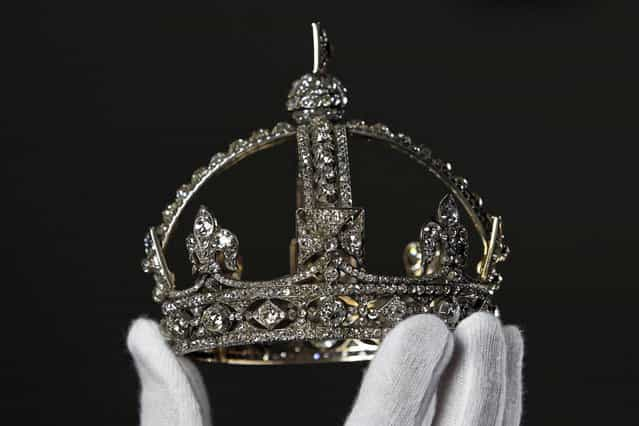 Exhibition curator Caroline de Guitaut poses with Queen Victorias Small Diamond Crown at the Queens Gallery in Buckingham Palace, London