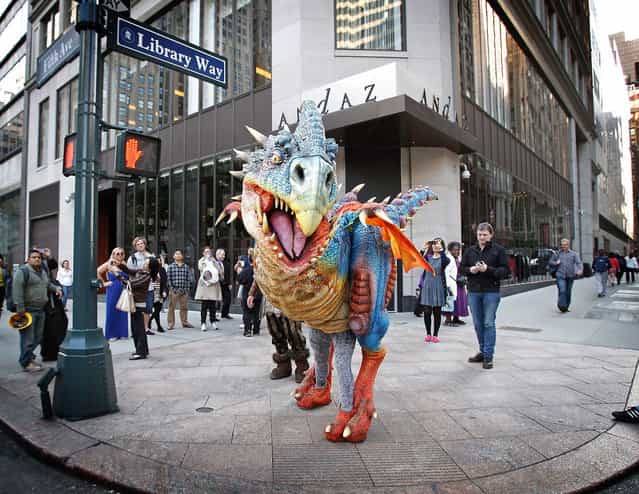 The Baby Nager dragon, from DreamWorks’ new [How to Train Your Dragon] Live Spectacular touring musical, shows off it’s colors outside of the New York Public Library