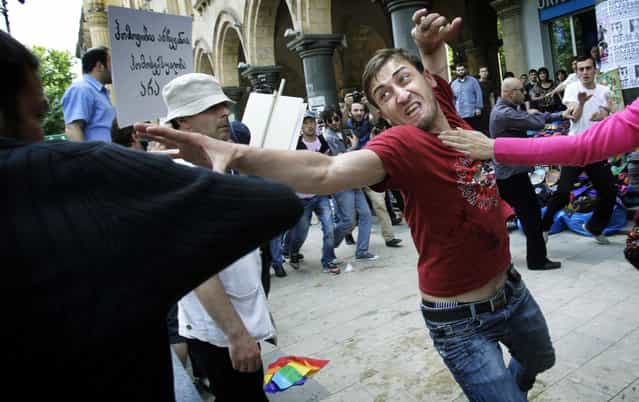 A gay rights activist, right, clashes with an Orthodox Christian activist in Tbilisi, Georgia