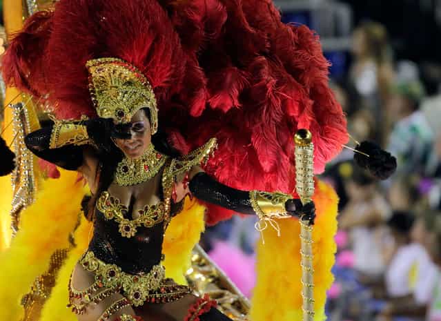 A reveller from the Sao Clemente samba school takes part in a parade on the second night of the annual Carnival parade in Rio de Janeiro's Sambadrome, on February 20, 2012
