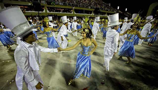 Couples dance during the Sao Clemente samba school's parade at the Sambadrome in Rio de Janeiro