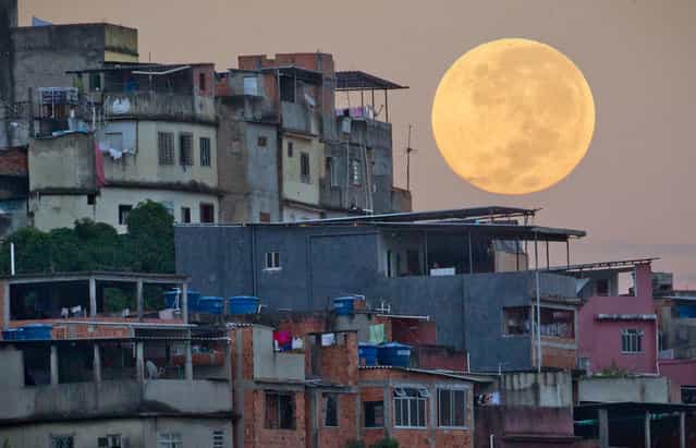 A full moon looms above the Mare shanty town complex in Rio de Janeiro, Brazil, on May 6, 2012