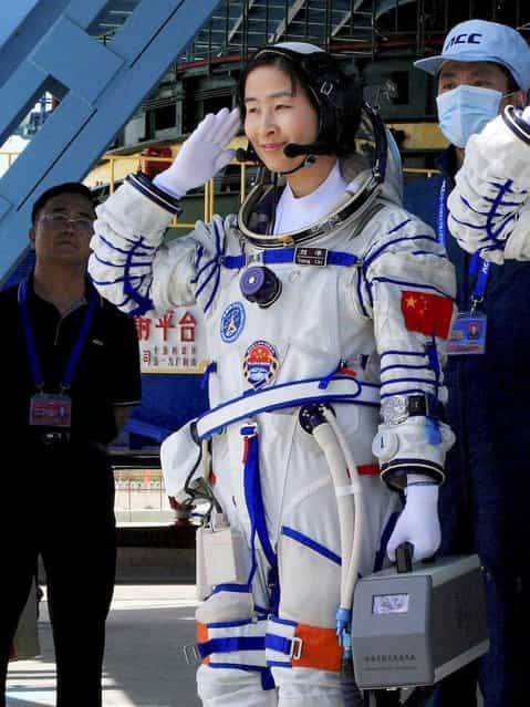Chinas first female astronaut Liu Yang, waves during a sending off ceremony before she departs for the Shenzhou 9 spacecraft rocket launch pad at the Jiuquan Satellite Launch Center in Jiuquan, China, Saturday, June 16, 2012