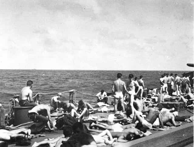 Crew sunbathing underway, port side of quarterdeck