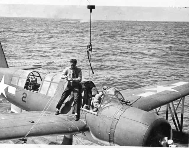 Lt. (jg) H.K.Anderson brings plane aboard after observation flight