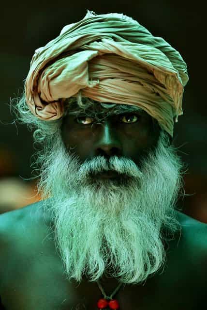 A Hindu holy man looks on as he waits to register for the annual pilgrimage to the Amarnath cave shrine in Jammu, India