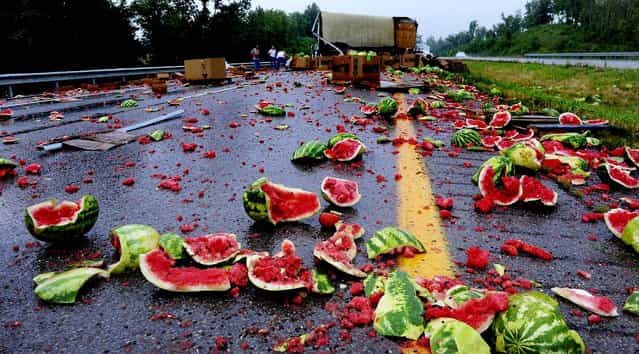 Splattered watermelons and tomatoes litter the roadway after an accident on the Breathitt-Pennyrile Parkway near Sebree, Kentucky