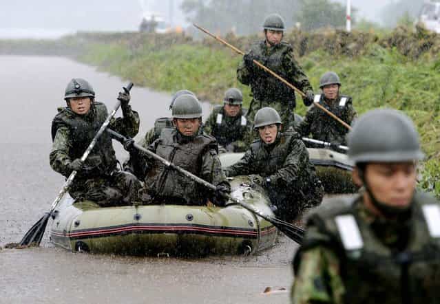 Japan's Ground Self-Defense Force personnel search for missing people in Aso, Kumamoto Prefecture on July 14, 2012