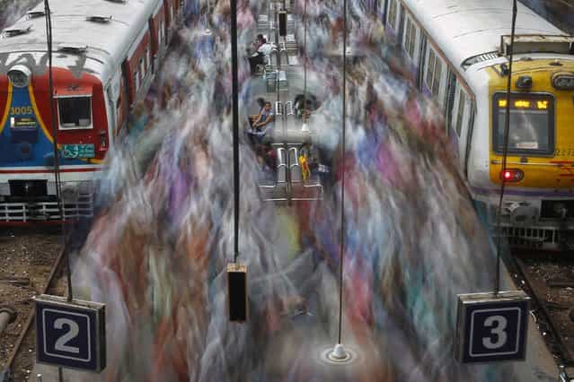 Commuters disembark from crowded suburban trains during the morning rush hour at Churchgate railway station in Mumbai, India on July 13, 2012