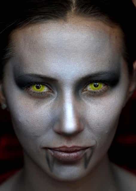 A woman is made up to look like a female vampire at the Comic-Con convention in Mexico City on July 21, 2012. (Photo by Marco Ugarte/Associated Press)