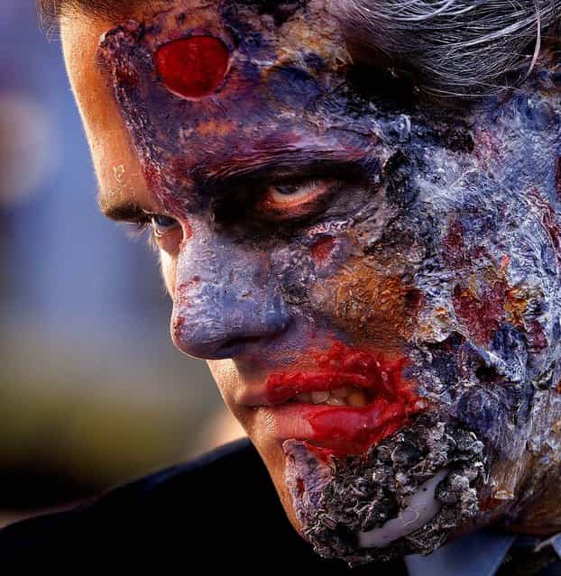 Batman fan Brian Haughs, 28, from Indiana, role plays as [Two-Face], a fictional supervillain, while waiting for the opening of The Dark Knight Rises, the third in Christopher Nolan's Batman trilogy, at Universal CityWalk in Los Angeles on July 19, 2012. (Photo by Damian Dovarganes/Associated Press)