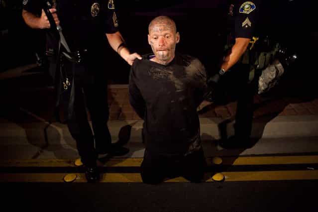 Police officers take a man into custody after he refused to disburse during a demonstration to show outrage for the fatal shooting of Manuel Angel Diaz, 25, at Anaheim City Hall on July 24, 2012 in Anaheim, California. Diaz was fatally shot on July 21 by an Anaheim police officer and has sparked days of protests by the angered community. (Photo by Jonathan Gibby)