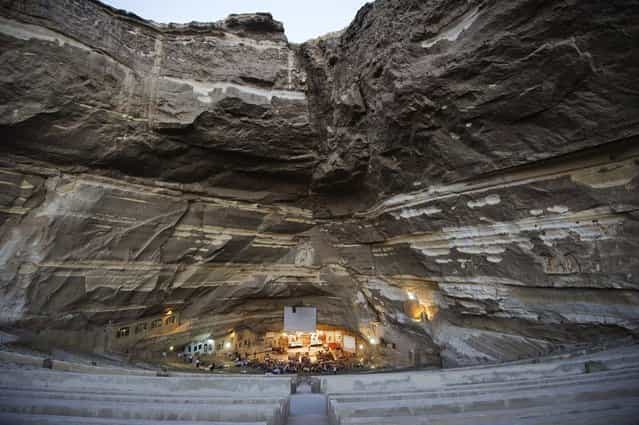 A general view of St Samaans (Simon) Church also known as the Cave Church in the Mokattam village, nicknamed as [Garbage City], is seen on July 26, 2012 in Cairo. Once a week hundreds gather at the Cave Church in Moqattam, after the prayer, a coptic priest performs exorcism or healing blessing to some of the believers. With a cross and holy water he fights spiritual entities and demons. The Monastery of St. Simon the Tanner is the largest and it has an amphitheater with a seating capacity of 20,000 making it the largest church in the Middle East. It is named after the Coptic Saint, Simon the Tanner, who lived at the end of the 10th century, when Egypt was ruled by the Muslim Fatimid Caliph Al-Muizz Lideenillah. Simon the Tanner is the Coptic Saint who is associated with the legend of the moving of the Mokattam Mountain. (Photo by Gianluigi Guercia/AFP)