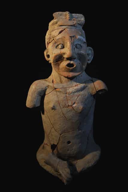 A repaired pottery statue found in Inner Mongolia autonomous region, July 3, 2012. (Photo by Xinhua)