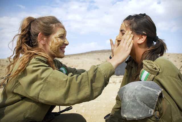 [Female Infantry Instructors Prepare for a Combat Exercise], November 16, 2010.. The Infantry Instructors Course includes a [Field Week] during which soldiers experience drills, live fire, combat exercises, sleeping out in the open, and other aspects of operational activity. The course is held in the Infantry Training School in southern Israel and is attended mostly by girls.