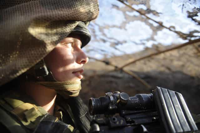 [The Life of Female Field Intelligence Combat Soldiers], November 2011. Female combat soldiers of the field intelligence company [Nachshol] are stationed along the southern Israeli border. Due to the increased tension in the area, a unique exercise was conducted in the beginning of November, practicing clashes with terrorists, storming at targets, and high-level camouflage, while confronted with mock explosives simulating real bombs.