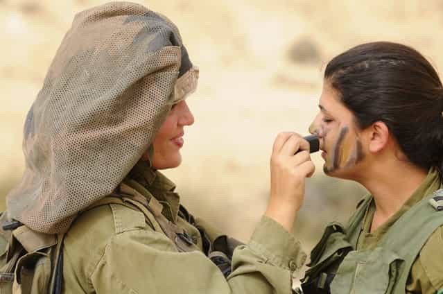[Field Training Week for Ground Forces], May 17, 2011. Weeks of exhausting practice all come down to a single moment- the concluding exercise that will award these female soldiers the title of combat instructors. At the end of the course the female soldiers will be placed in different positions, instructing IDF Ground Forces. Minutes before stepping foot in the simulated battlefield, they make their final preparations.