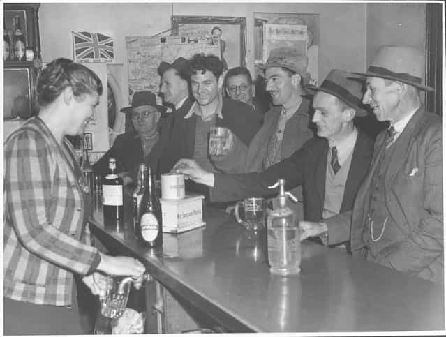 Mrs Gleeson pours a beer for a customer at the Drouin Hotel, Drouin, Victoria, 1944. Wife of Drouin publican (Mrs. James J. Gleeson) pours beer for customers. A pot like this (11oz.) costs 81/2 d. about half of which goes in excise to Australian government. Australian beer has 8% alcohol - heavier than American beer but about the same as British. Mrs Gleeson has two sons fighting the Jap; says she has never had a customer she could not handle in her 23 years at the Drouin Hotel